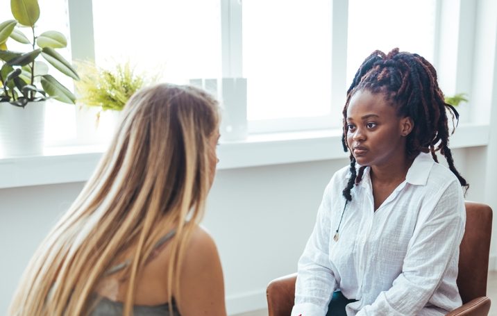 Two women conversing in a compassionate manner